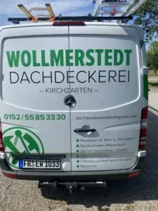 Auf der Rückseite eines Lieferwagens steht „Wollmerstedt Dachdeckerei Kirchzarten“ und Kontaktdaten.